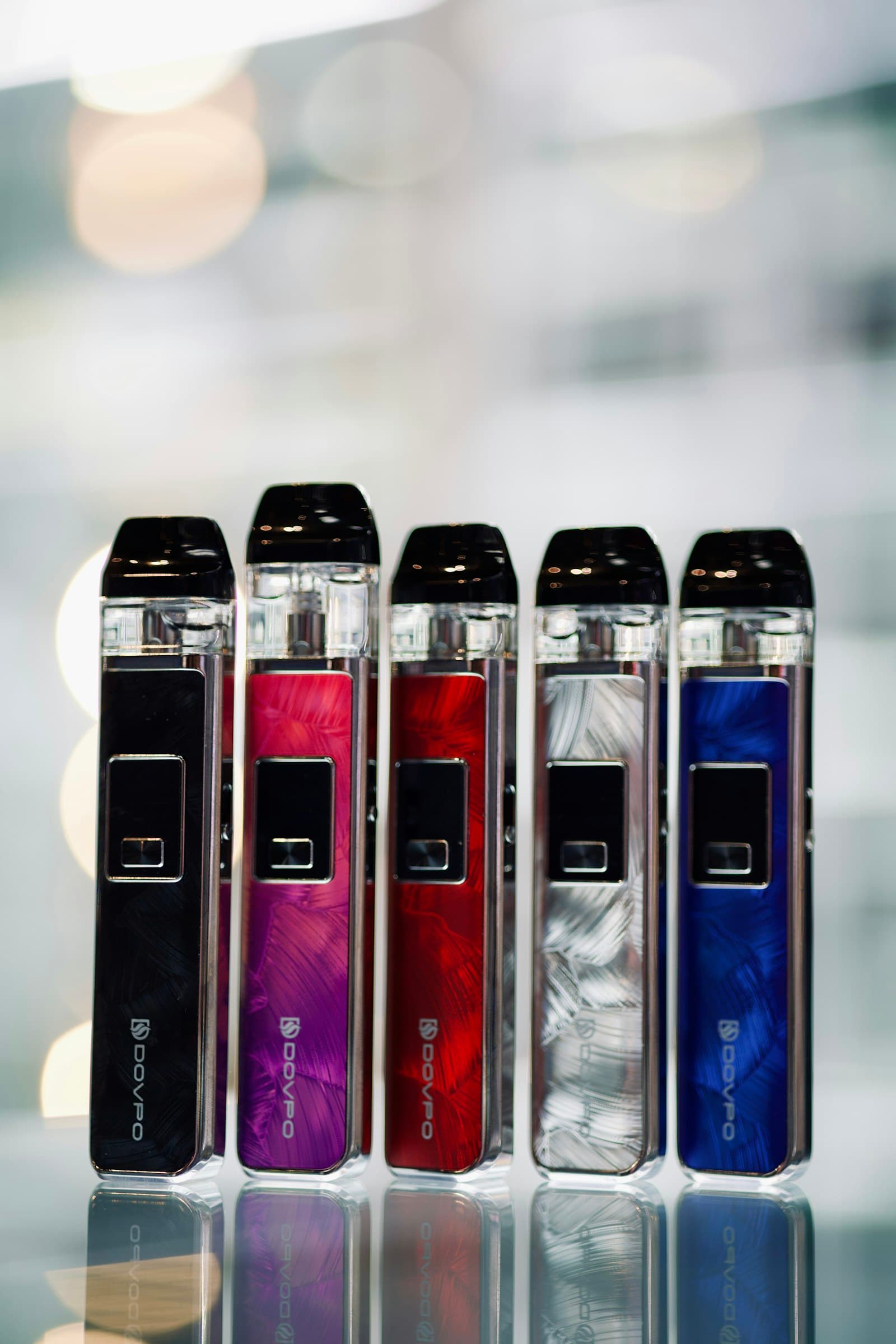 Several different pod-system vape kits of varying sizes arranged together for comparison